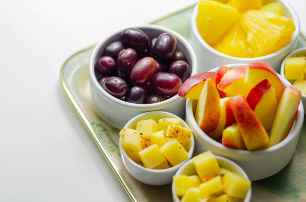 istock Various set fruits, pineapple, apple, grapes with matured cheddar cheese in bowls 1215685966