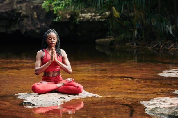istock Woman meditating in forest 1215685967