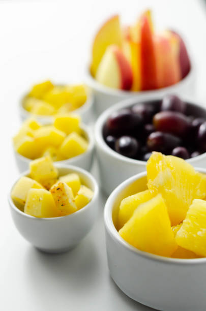 istock Various set fruits, pineapple, apple, grapes with matured cheddar cheese in bowls 1215686494