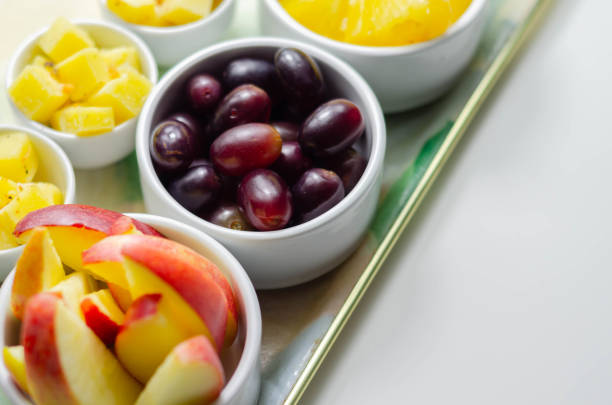 istock Various set fruits, pineapple, apple, grapes with matured cheddar cheese in bowls 1215686552