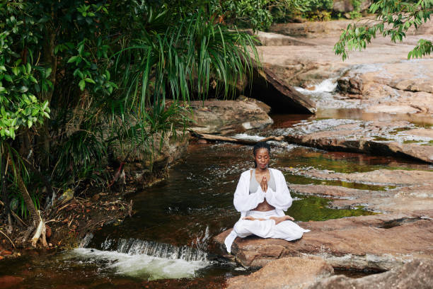 istock Woman meditating in nature 1215686731