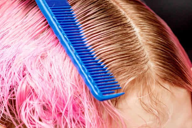 istock Hands combs hair of woman. 1215687618