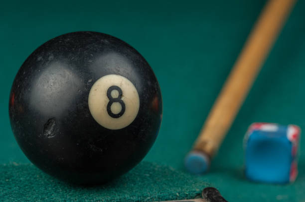 istock Billiards balls and cue on billiards table. Billiard sport concept 1215688871