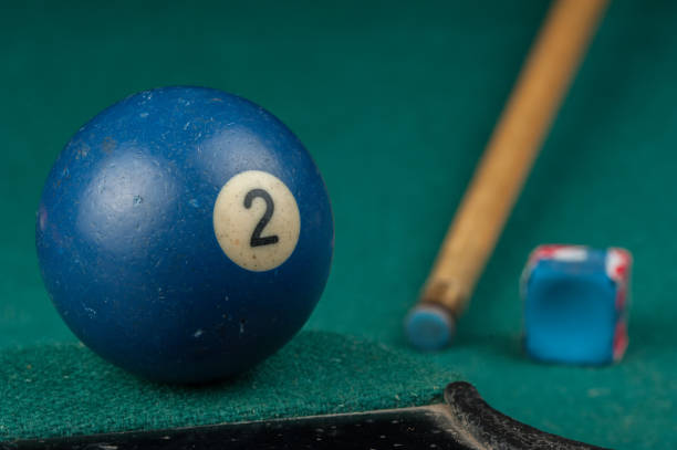 istock Billiards balls and cue on billiards table. Billiard sport concept 1215689072