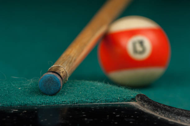 istock Billiards balls and cue on billiards table. Billiard sport concept 1215689690