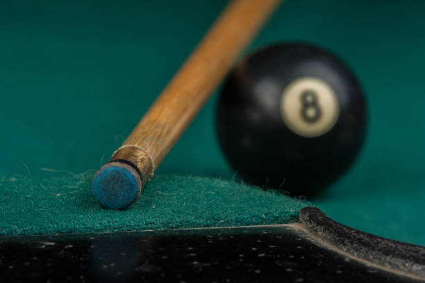 istock Billiards balls and cue on billiards table. Billiard sport concept 1215689819