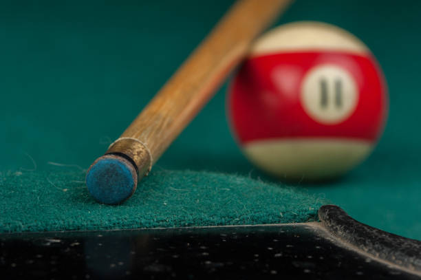 istock Billiards balls and cue on billiards table. Billiard sport concept 1215689871