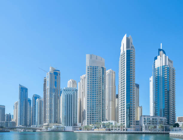 istock Pattern of office buildings windows. Glass architecture facade design with reflection in urban city, Downtown Dubai. Urban city in financial district with blue sky. 1215689902