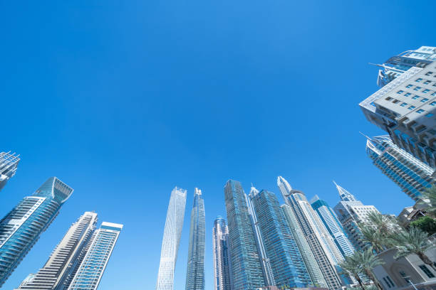 istock Pattern of office buildings windows. Glass architecture facade design with reflection in urban city, Downtown Dubai. Urban city in financial district with blue sky. 1215690314