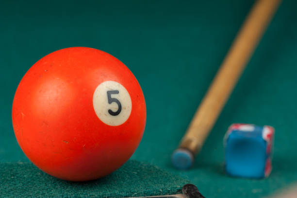 istock Billiards balls and cue on billiards table. Billiard sport concept 1215690412