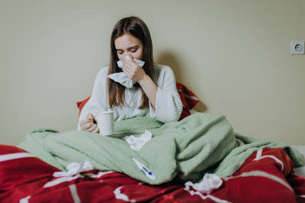 istock Woman sick in bed, covered with blanket 1215690486