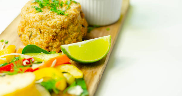 istock Smoked haddock fishcake with slices fried potatoes and mixed salad 1215690763