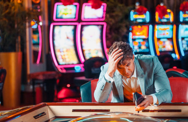 Man loosing his money in the casino Man loosing his money in the casino clubwear stock pictures, royalty-free photos & images