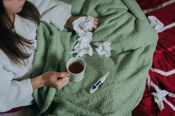 istock Woman sick in bed, covered with blanket 1215691870