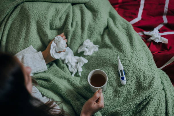 istock Woman sick in bed, covered with blanket 1215692189