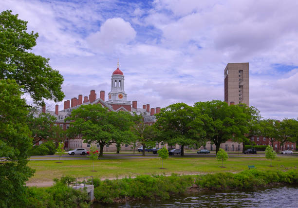 istock Clock tower and green footpath along Charles River in Harvard University campus in Boston 1215692945