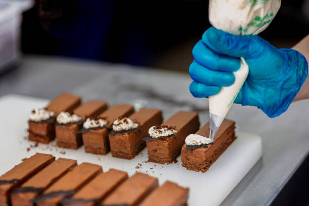 istock Confectioner makes a chocolate cake decorated with coffee grains 1215693498