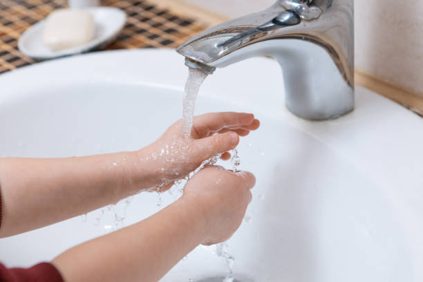 istock Close-up kids hands washing hands with soap 1215693618