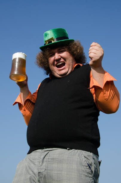 istock Funny fat man is drinking beer. 1215693652