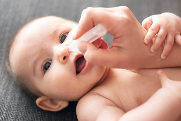 istock Newborn baby and nose drops 1215695370