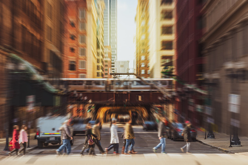 Blurred Crowd of Chicago street with traffic road intersection among modern buildings