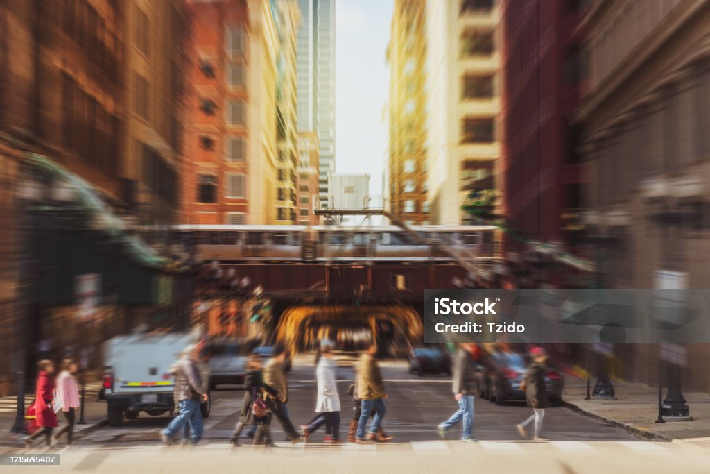 Blurred Crowd of Chicago street with traffic road intersection among modern buildings Blurred Crowd of Chicago street with traffic road intersection in rush hour among modern buildings of Downtown Chicago Chicago - Illinois Stock Photo