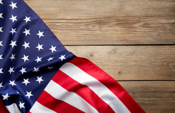 istock American flag on grey wooden background with copy space 1215696533