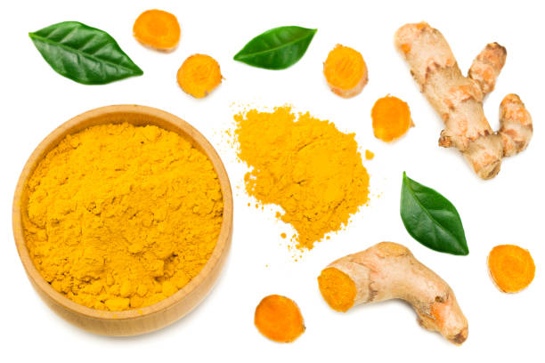 istock Turmeric powder with turmeric root isolated on white background. Top view. 1215696735