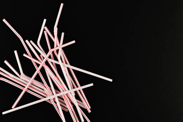 istock plastic tubules on a black background. randomly scattered. place for an inscription. view from above 1215698159