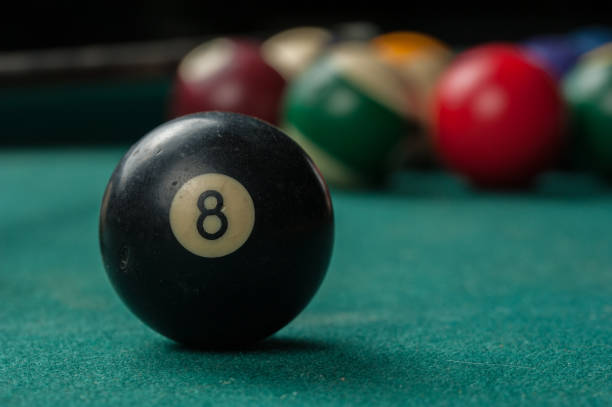 istock Billiards balls and cue on billiards table. Billiard sport concept 1215698408