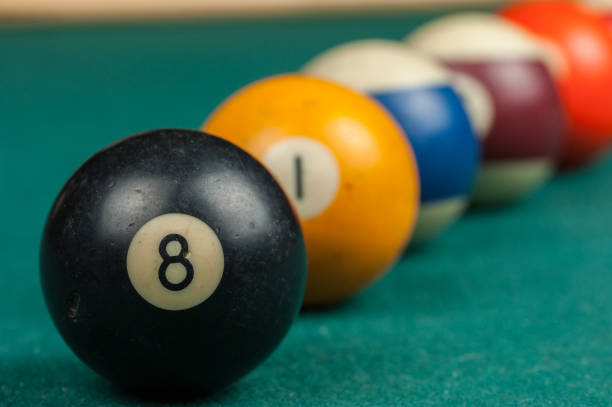 istock Billiards balls and cue on billiards table. Billiard sport concept 1215698471