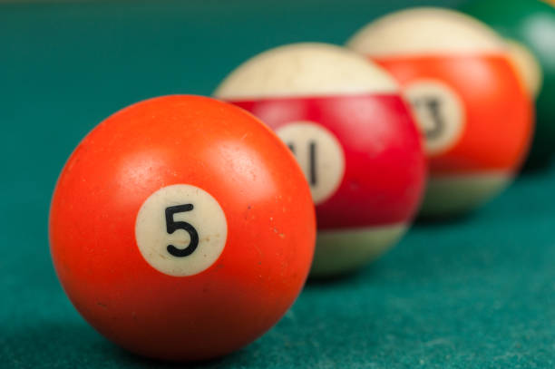 istock Billiards balls and cue on billiards table. Billiard sport concept 1215698563