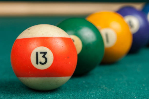 istock Billiards balls and cue on billiards table. Billiard sport concept 1215698655