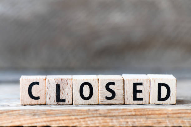istock CLOSED. Word arranged from wooden letters Closed. 1215698741