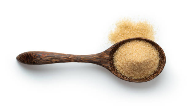 istock brown sugar in wood spoon isolated on white background. Top view 1215698773
