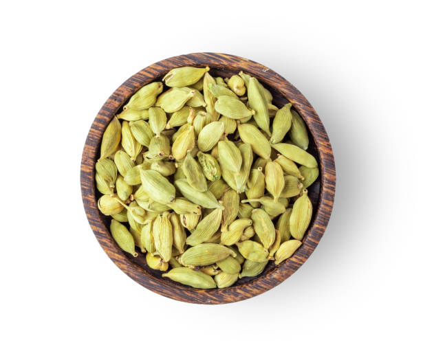 Top view of group of cardamom in wood bowl isolated on white background Top view of group of cardamom in wood bowl isolated on white background Cardamom stock pictures, royalty-free photos & images