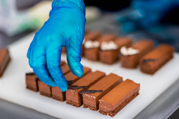 istock Confectioner makes a chocolate cake decorated with coffee grains 1215700852