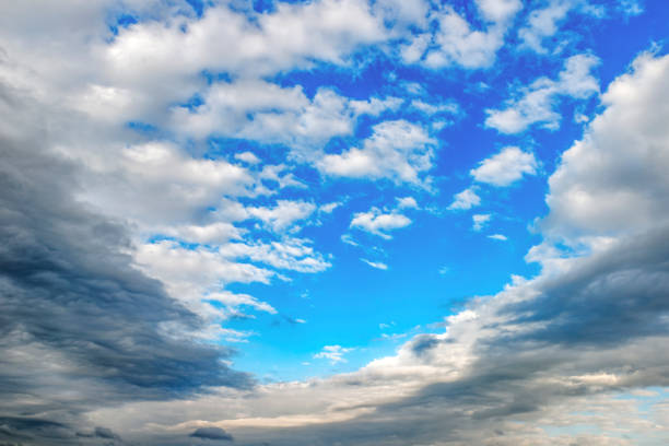 Texture of gray white clouds on a blue sky, background.