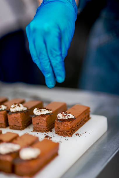 istock Confectioner makes a chocolate cake decorated with coffee grains 1215701986