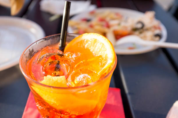 istock man drinking a cocktail on a table outdoors 1215703509