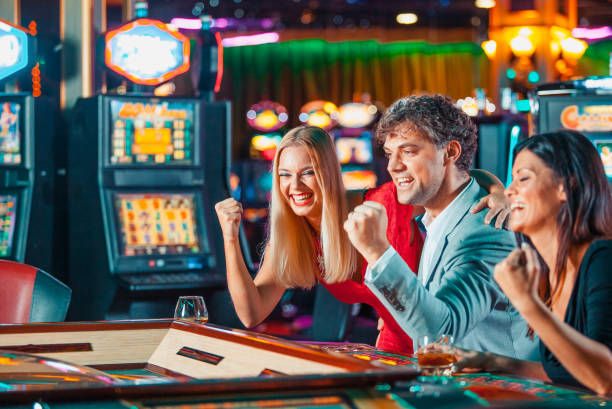 Group Of People Playing Slots In Casino. Stock Photos, Pictures &  Royalty-Free Images - iStock