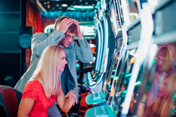 istock Couple loosing on a slot machine 1215704098