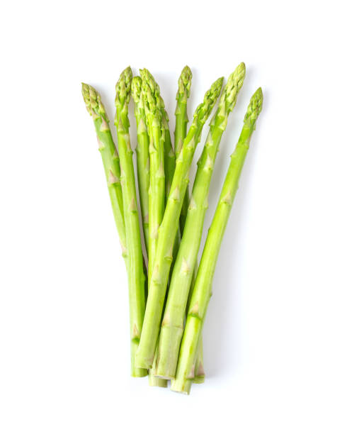istock fresh asparagus isolated on white background. top view 1215704151
