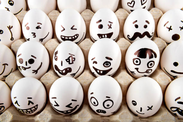 istock Eggs with drawn cartoon faces in tray. 1215705267