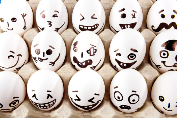 istock Eggs with drawn cartoon faces in tray. 1215705289