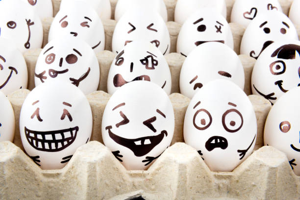 istock Eggs with drawn cartoon faces in tray. 1215705291