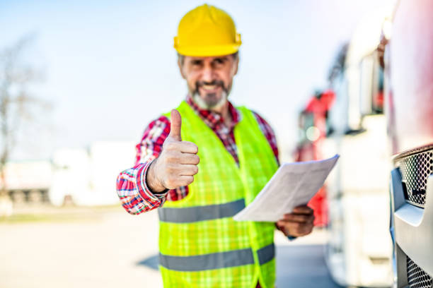 istock Truck driver delivering a load and showing thumb up. 1215705880