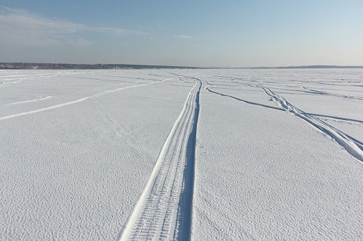 Trail from a snowmobile on a frozen river, Ob reservoir, Novosibirsk, Russia