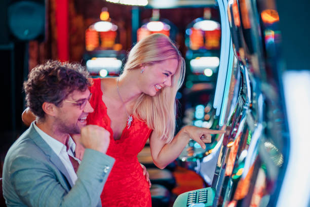 istock Couple winning on a slot machine 1215707497