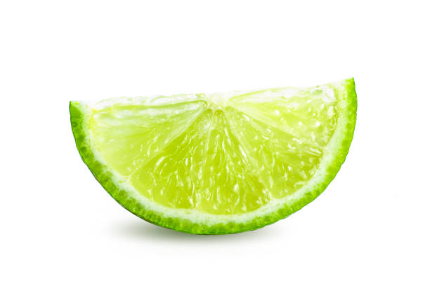istock Juicy slice of lime isolated on white background 1215707641